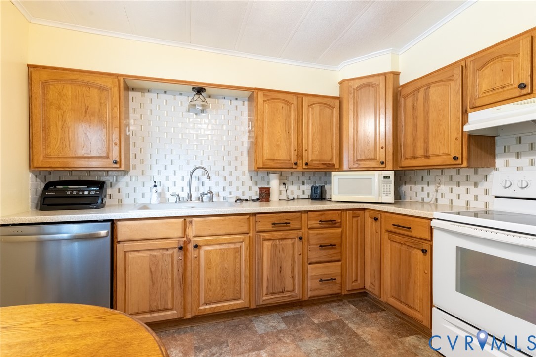 173 Antioch Road Warfield, VA 23889 - Photo 5 of 26 a kitchen with stainless steel appliances granite countertop a sink a stove and cabinets