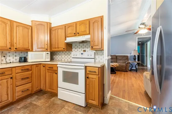 a kitchen with a refrigerator sink and cabinets