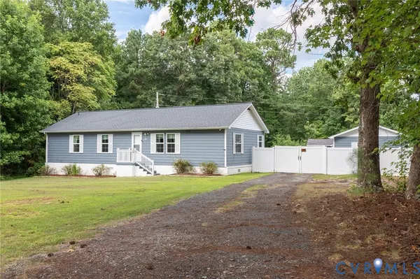 a front view of a house with yard and green space