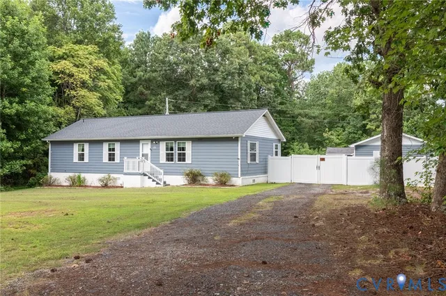 a front view of a house with yard and green space