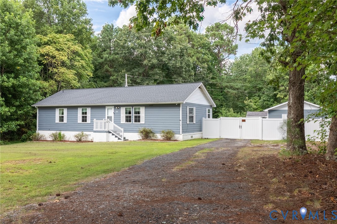 173 Antioch Road Warfield, VA 23889 - Photo 8 of 26 a front view of a house with yard and green space