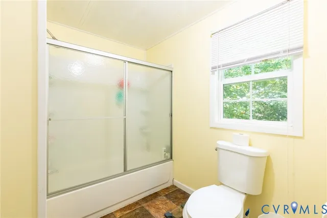 a bathroom with a toilet and a shower