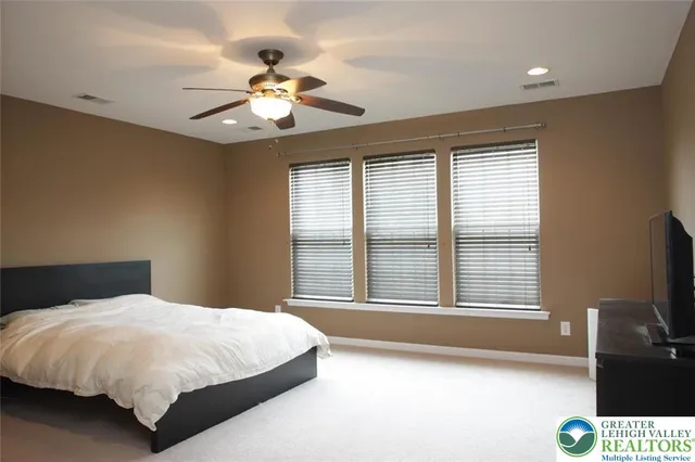 a bedroom with a large bed and a large window