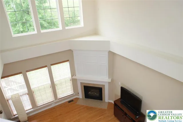 a living room with a fireplace and windows