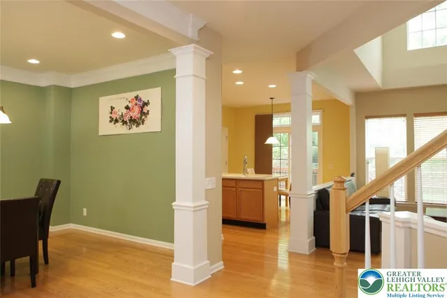 a view of a hallway with furniture and windows