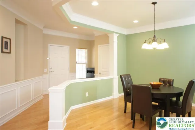 a view of a dining room with furniture and chandelier