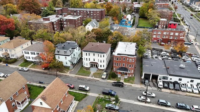 an aerial view of a house with a yard
