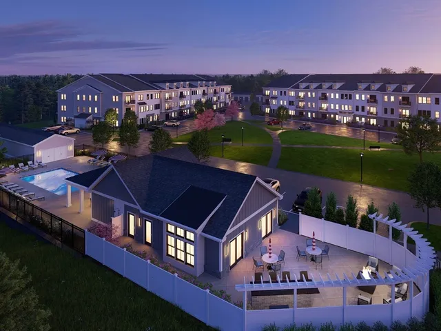 an aerial view of residential houses with outdoor space and city view