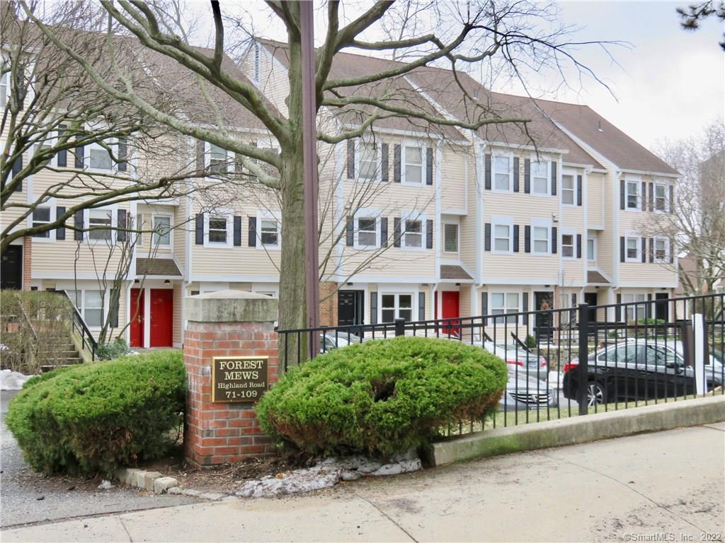 83 Highland Road, Unit 83 Stamford, CT 06901 - Photo 1 of 1 a front view of a building with a garden and plants