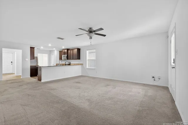 a view of a kitchen with a sink and a window