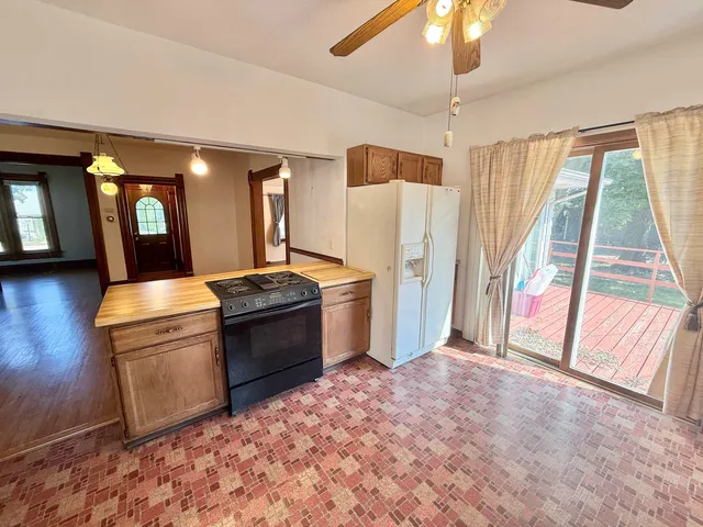 a kitchen with stainless steel appliances granite countertop a refrigerator and a sink