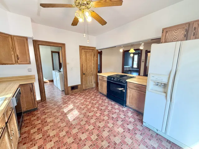 a kitchen with a refrigerator and a sink