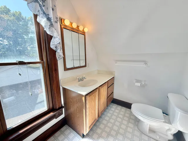 a bathroom with a sink a toilet and mirror