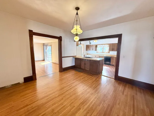 a view of kitchen with granite countertop cabinets and wooden floor