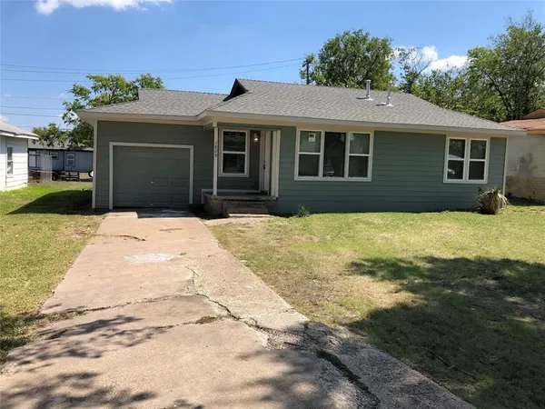 a front view of a house with yard patio and green space
