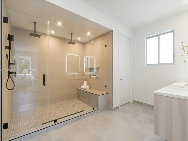 a bathroom with a shower and a sink