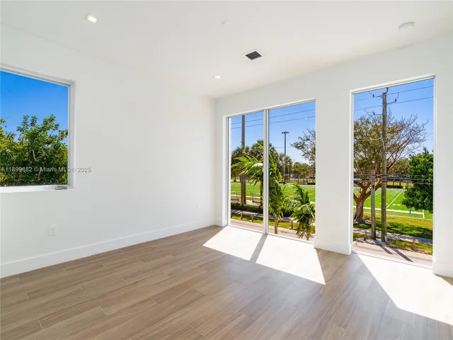 a view of an entryway with wooden floor and door