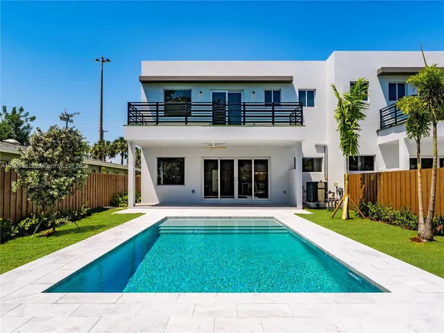 a view of white house with a yard