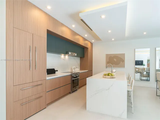 a large white kitchen with cabinets