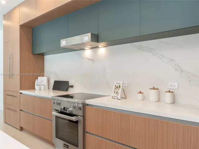 a kitchen with a sink cabinets and stainless steel appliances