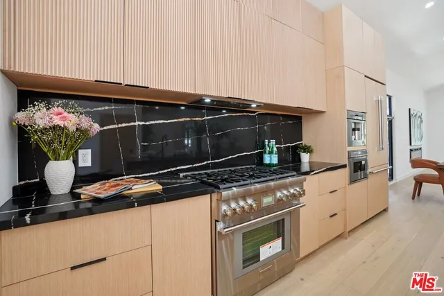 a stove top oven sitting inside of a kitchen