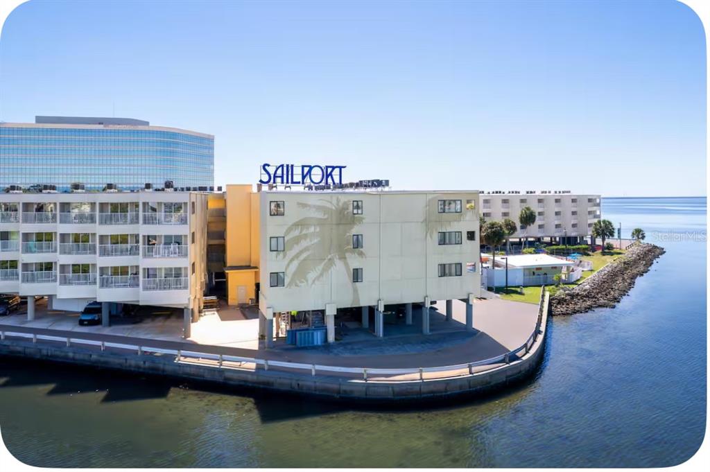 a living room with furniture and view of kitchen