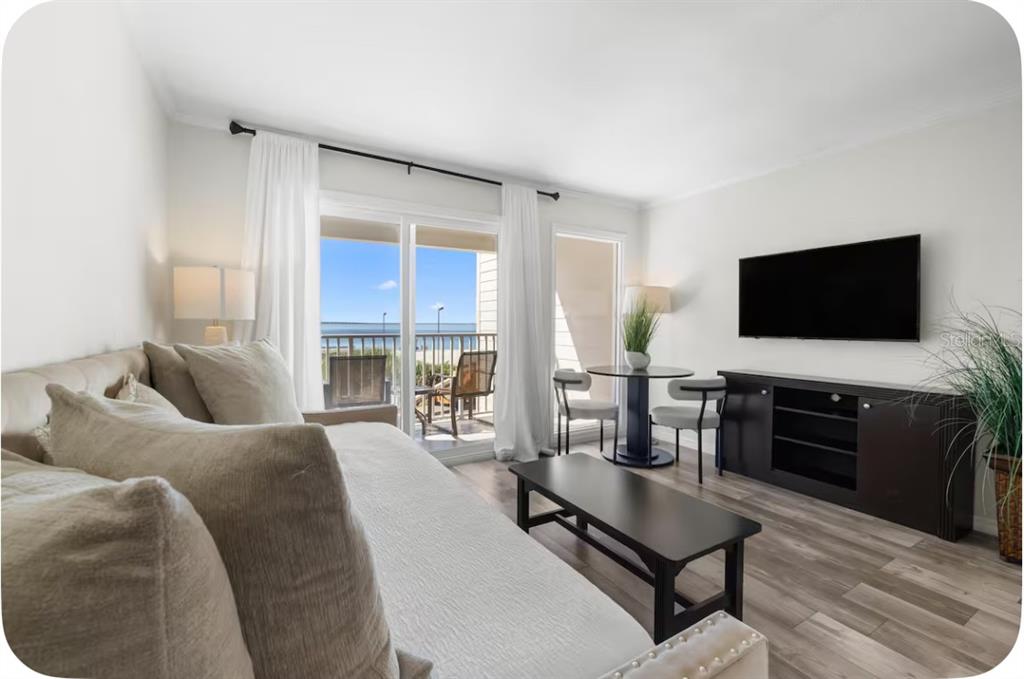 2506 North Rocky Point Drive, Unit 209 Tampa, FL 33607 - Photo 6 of 12 a living room with furniture and a flat screen tv