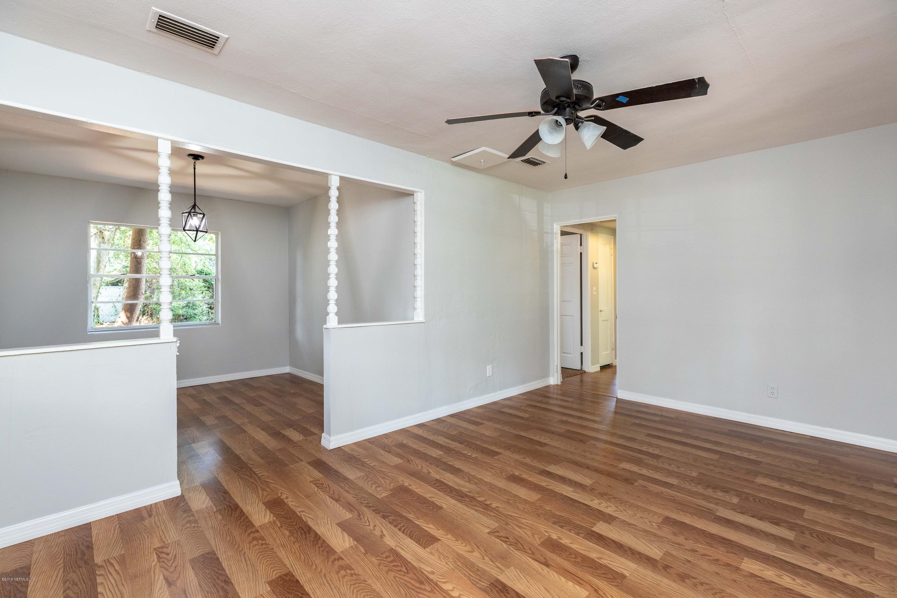 5318 South River Road Jacksonville, FL 32211 - Photo 2 of 32 a view of an empty room with wooden floor and a window