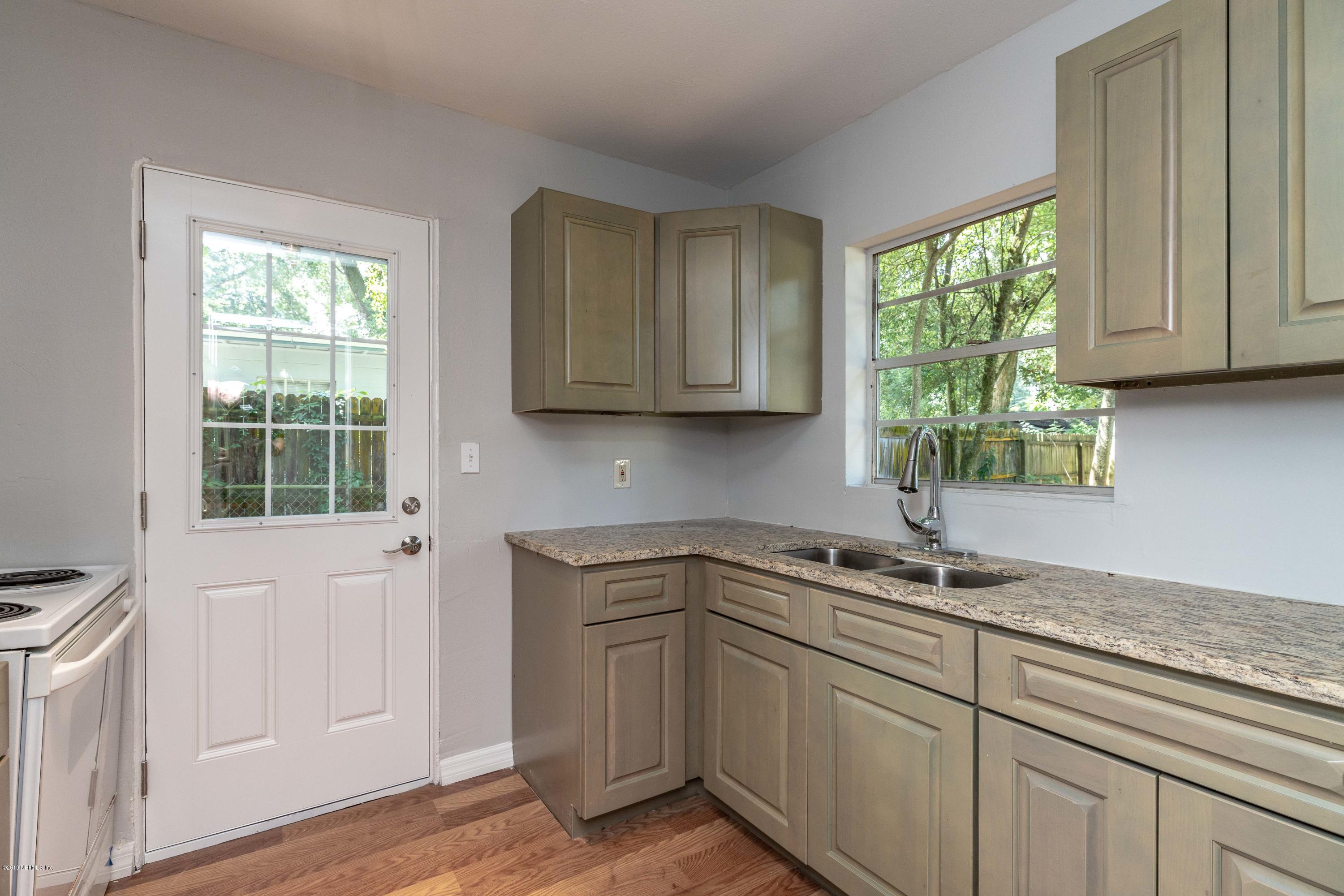 5318 South River Road Jacksonville, FL 32211 - Photo 8 of 32 a kitchen with stainless steel appliances granite countertop white cabinets and a window