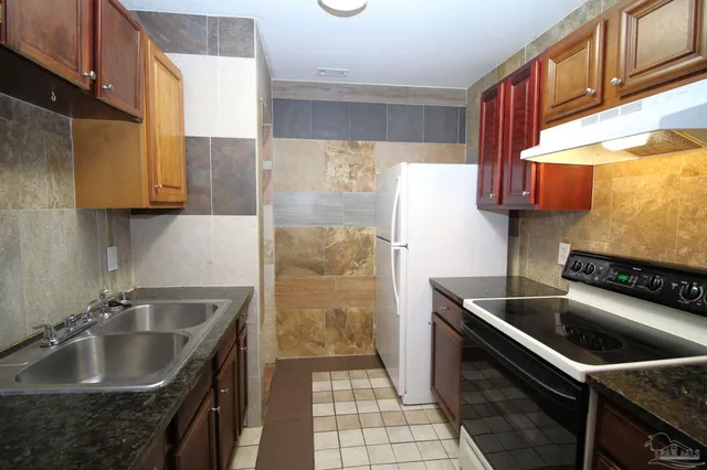 a kitchen that has a sink and a stove