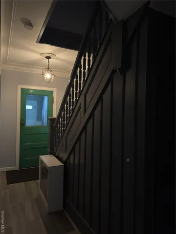 a view of entryway and hall with wooden floor