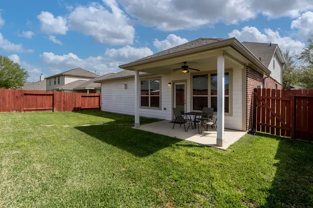 a view of a house with backyard porch and sitting area