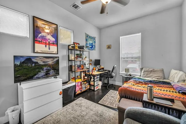 a bedroom with furniture and a flat screen tv