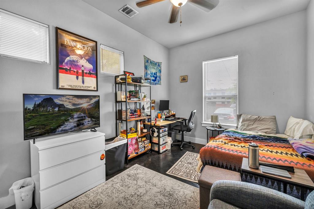 4517 Depew Avenue Austin, TX 78751 - Photo 14 of 20 a bedroom with furniture and a flat screen tv