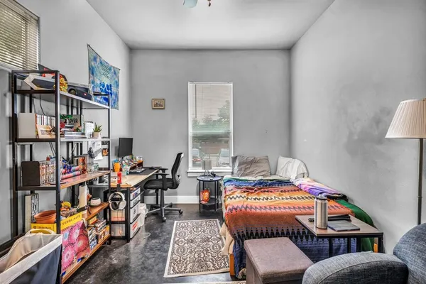 a bedroom with furniture and a book shelf