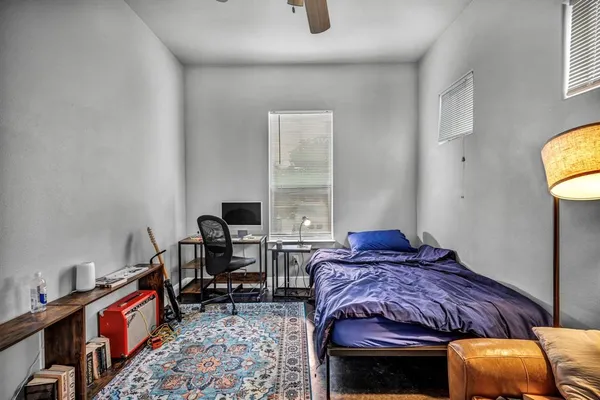 a bed room with a bed and a chair