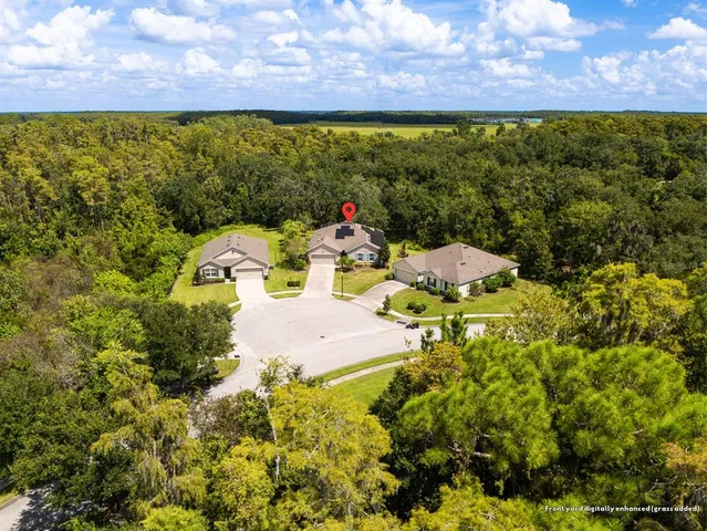 an aerial view of a house with a garden and swimming pool