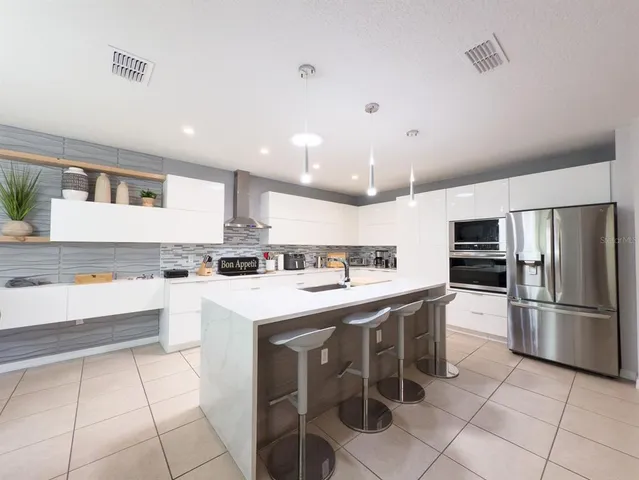 a large bathroom with a granite countertop sink a toilet a mirror and shower