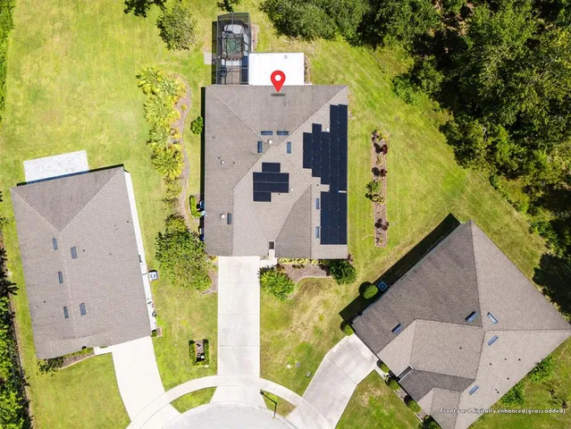 an aerial view of a house with a yard