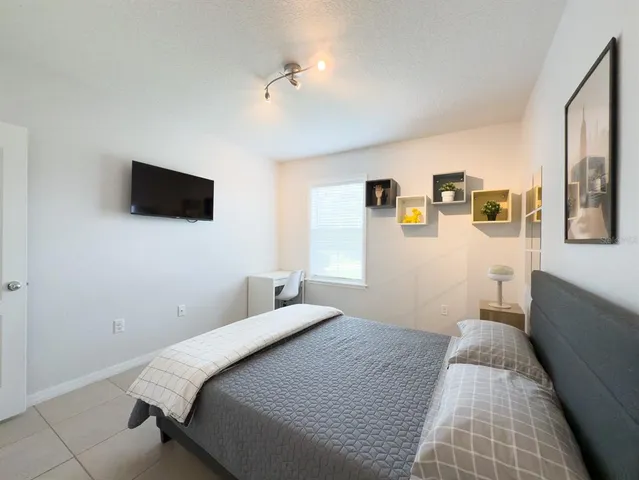 a bathroom with a granite countertop tub sink and mirror