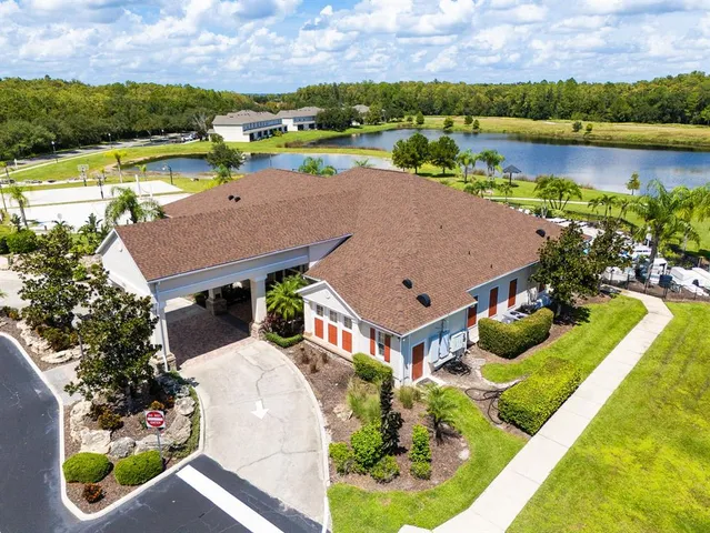 an aerial view of a house with a swimming pool outdoor seating and yard