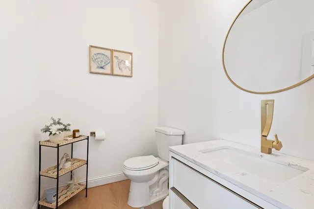 a bathroom with a sink mirror and toilet