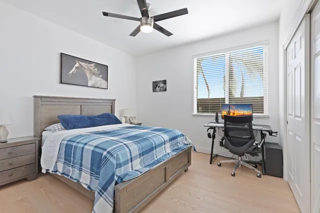 a bedroom with a bed and a desk