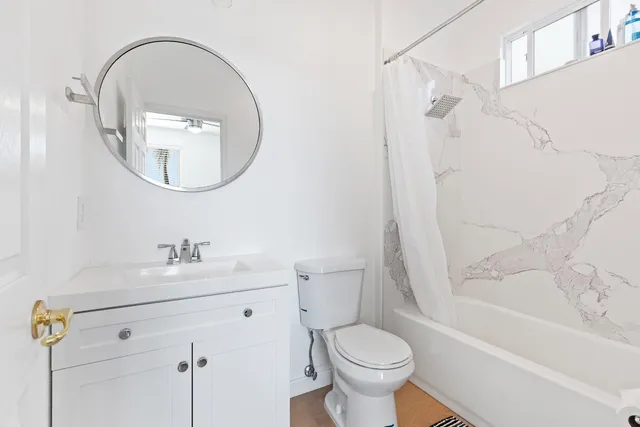a bathroom with a sink toilet and shower