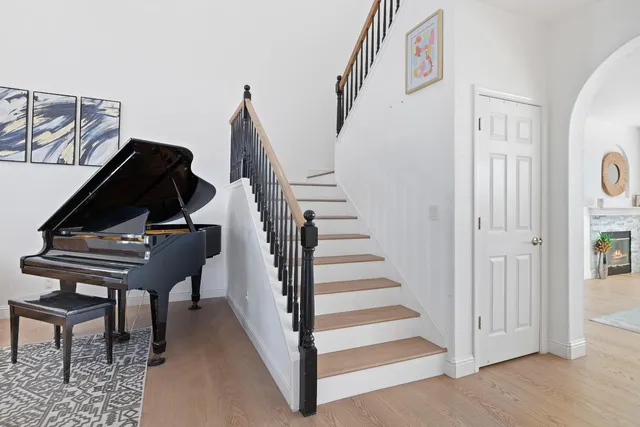 a view of entryway and hall with wooden floor