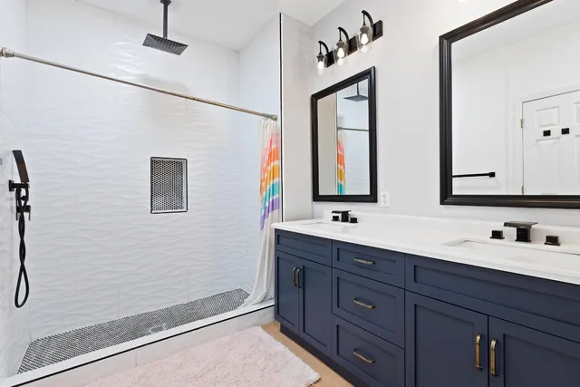 a bathroom with a double vanity sink and mirror