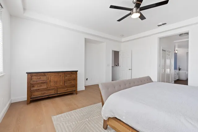 a bedroom with a bed and cabinets