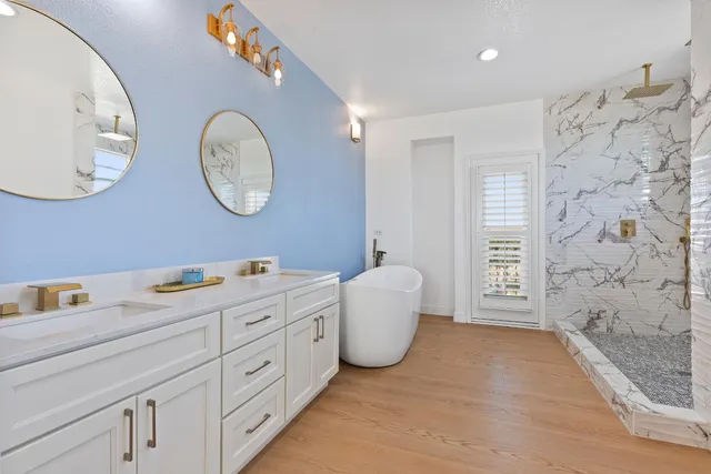a spacious bathroom with a double vanity sink and a mirror