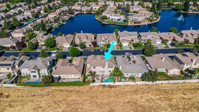 an aerial view of a house with a lake view