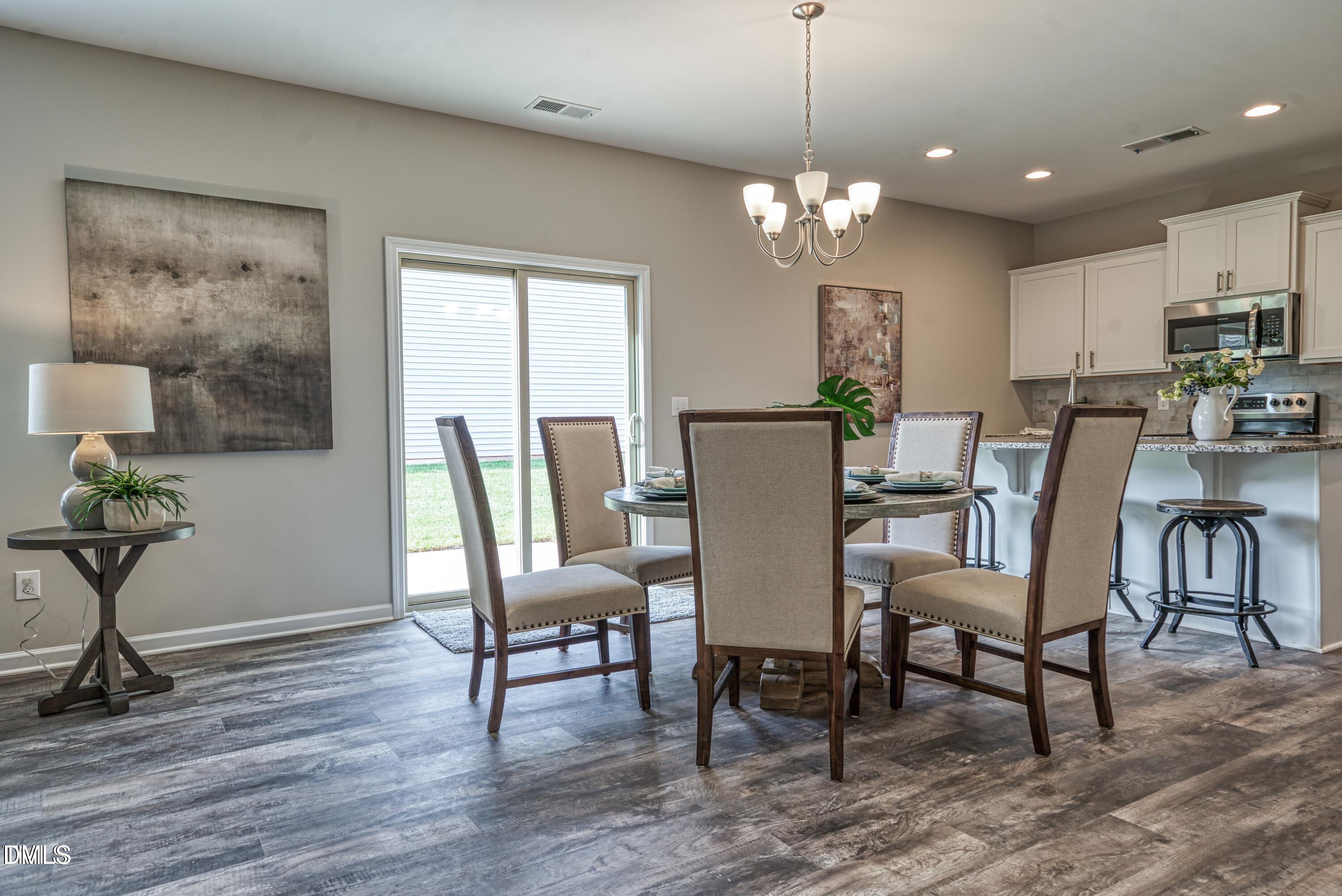 2304 Broad Street Durham, NC 27704 - Photo 11 of 39 a view of a dining room with furniture window and wooden floor
